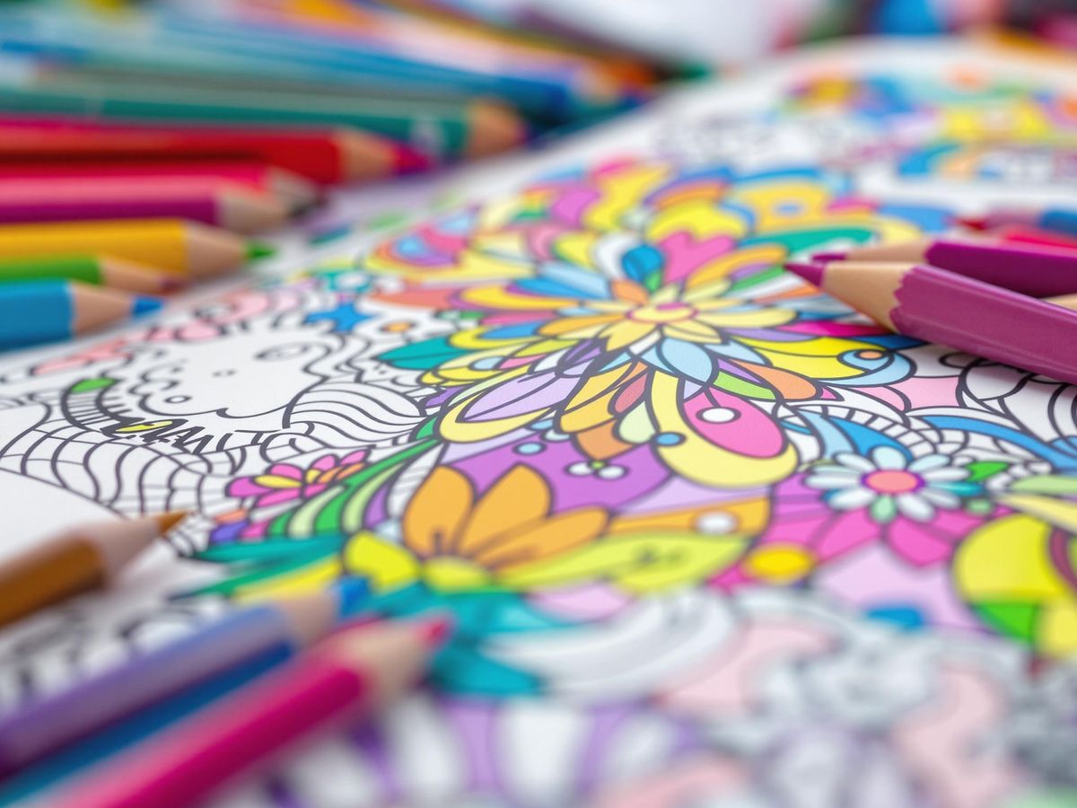 Coloring book with colored pencils for relaxation and creativity.